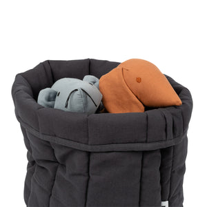 storage basket with dog toys in it