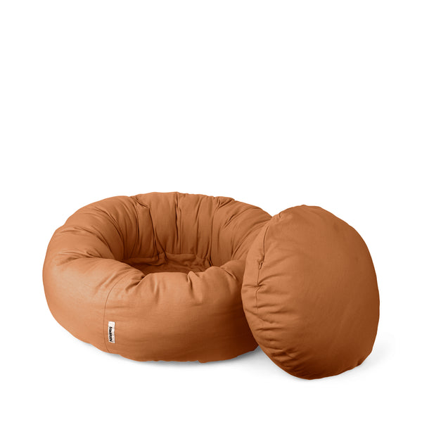a light brown donut bed where the inner cushion is removed